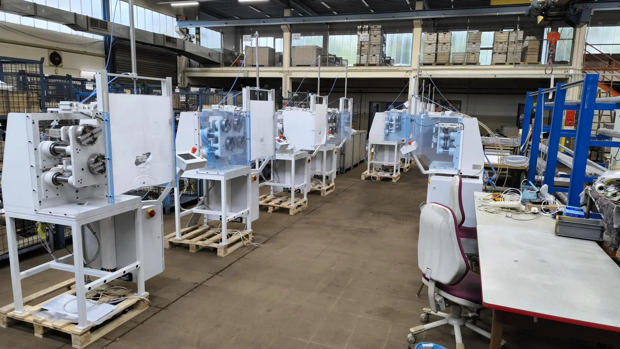Row of refurbished winding machines on the shop floor, ready for delivery